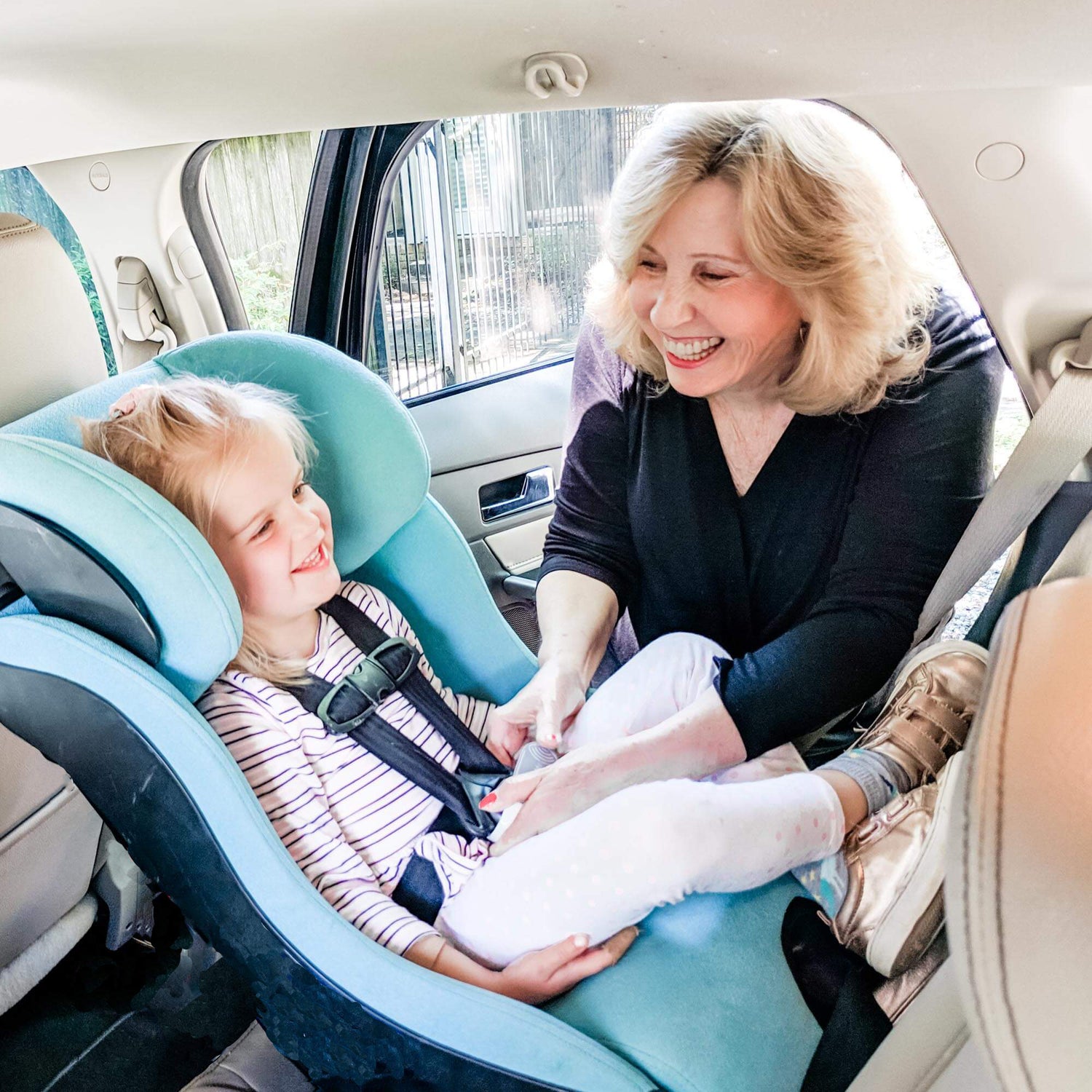 Photo of Grandma using UnbuckleMe to open a child's car seat