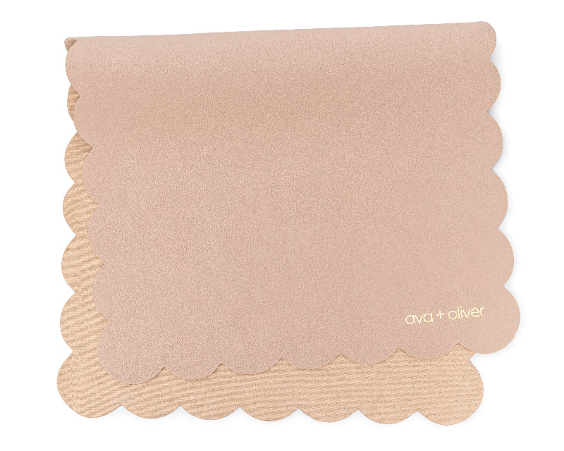 A folded vegan leather changing mat with a matte, pink sand scallop texture, featuring the brand name 'ava + oliver' at the bottom.